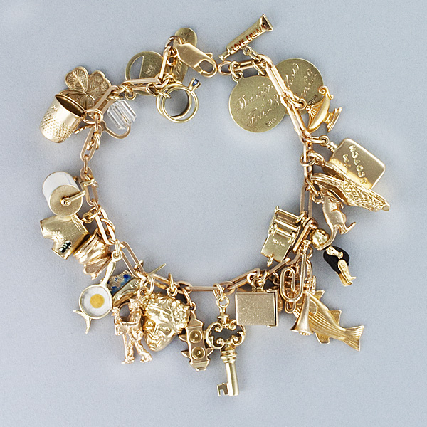 Assorted charm bracelet in 14k yellow gold. Length 7.5 inches. image 6