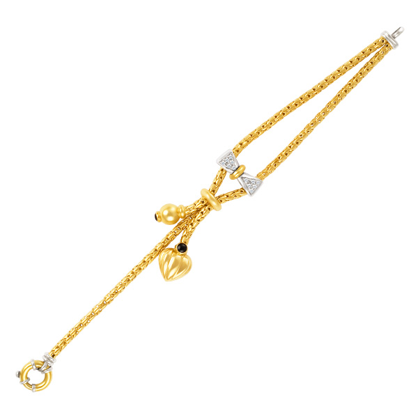 Bow bracelet in 18k white and yellow gold