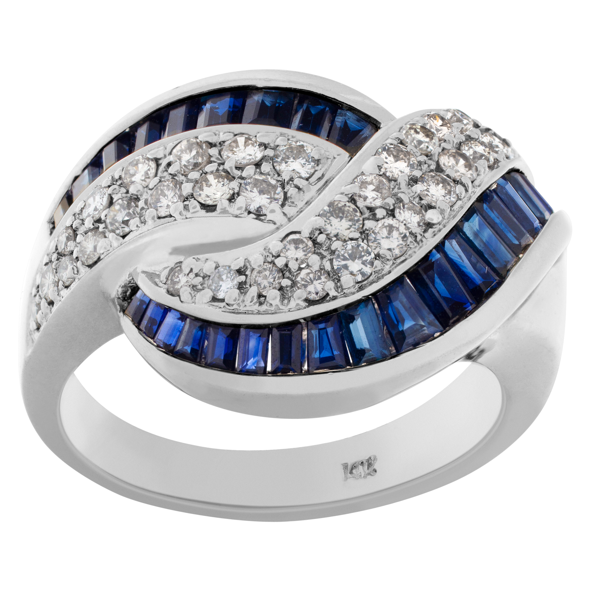 Criss-Cross sapphire & diamond ring in 14K white gold. Approx 1 carat tapered emerald cut sapphire and 0.75 carat full cut round diamond.
