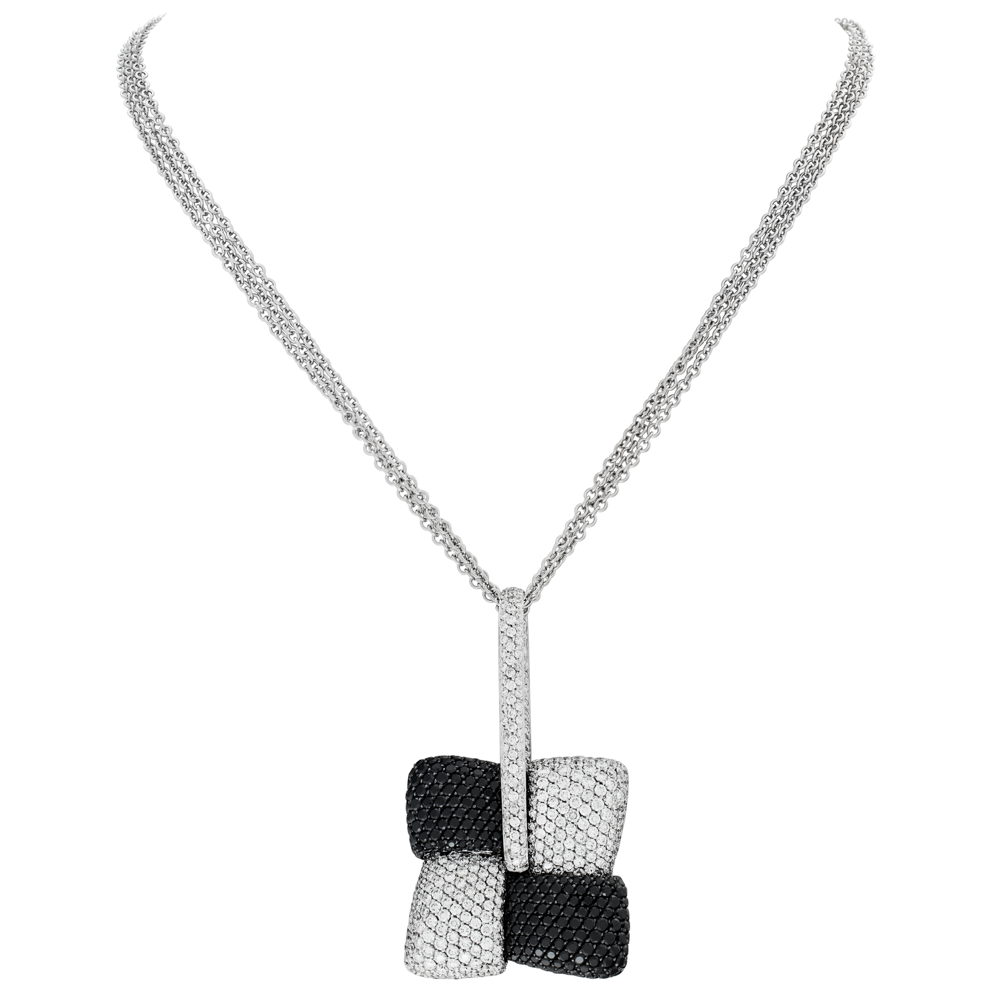 Elegant pave dia pendant + necklace in 18k gold with appx 5 cts white dias and 4.7 cts black dias