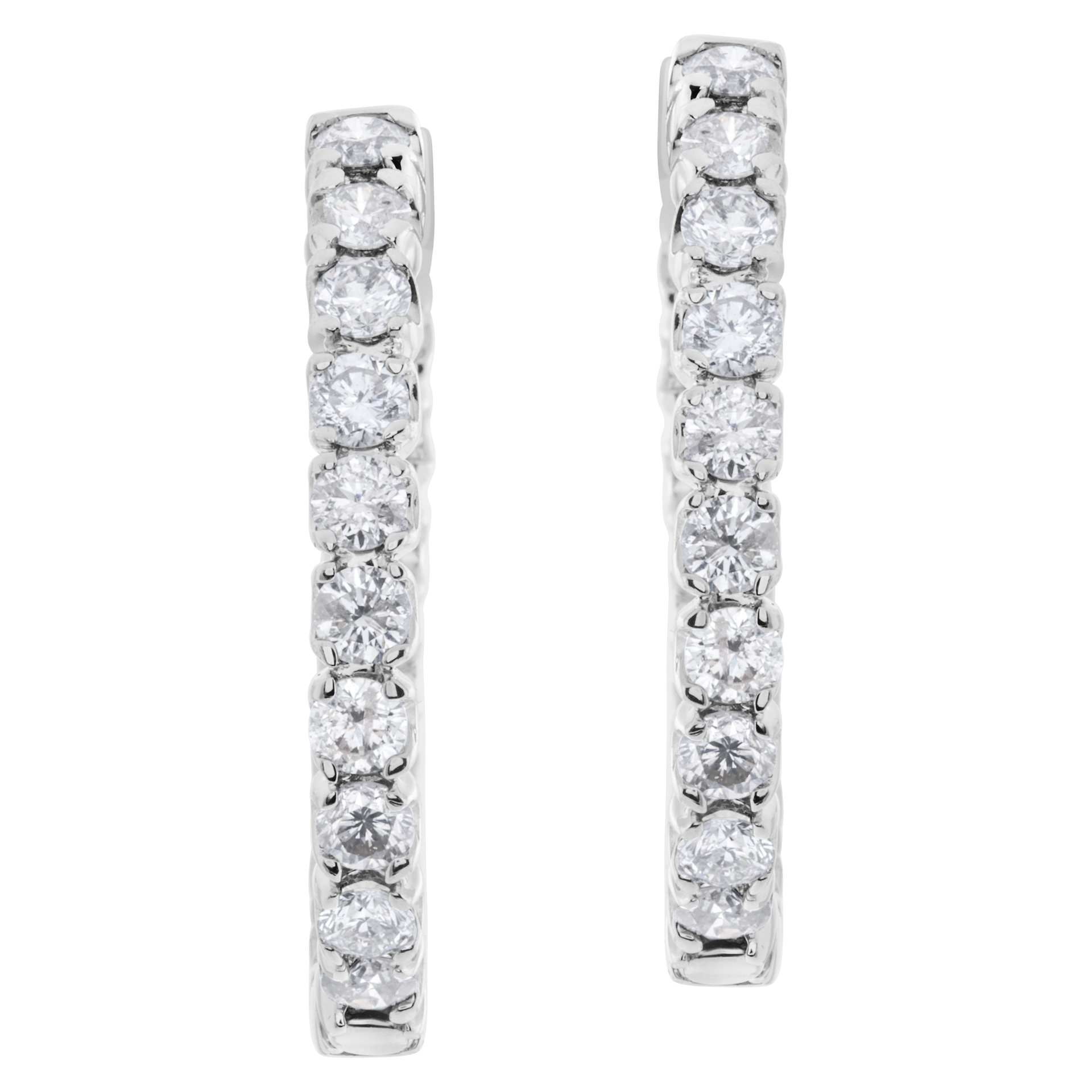Diamond hoop earrings in 14k white gold with over 3 carats in round diamonds. 1 inch diameter